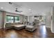 Open concept living room featuring hardwood floors, recessed lighting, and large sliding glass doors at 30215 Bretton Loop, Mount Dora, FL 32757