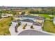 Aerial view of a four-unit townhome community with attached garages and a golf course view at 880 Driving Range Ct, Reunion, FL 34747