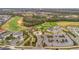 Stunning aerial view highlighting the community's prime location with lush golf course, and neighborhood at 880 Driving Range Ct, Reunion, FL 34747