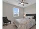 Bedroom with queen-size bed, ceiling fan, and window at 880 Driving Range Ct, Reunion, FL 34747