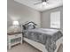 Cozy bedroom boasts a plush queen-sized bed, a decorative headboard, and a charming nightstand with a stylish lamp at 880 Driving Range Ct, Reunion, FL 34747