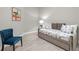 Bedroom with daybed, chair, and art at 880 Driving Range Ct, Reunion, FL 34747