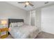 Bedroom with queen bed, closet, and ceiling fan at 880 Driving Range Ct, Reunion, FL 34747