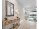 Light and airy entryway with console table, mirror, and view to living room at 880 Driving Range Ct, Reunion, FL 34747