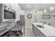 Modern kitchen with white cabinets, stainless steel appliances, and gray island at 880 Driving Range Ct, Reunion, FL 34747