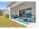 Charming outdoor patio featuring comfortable seating, perfect for relaxing or entertaining, offering seamless indoor-outdoor living at 880 Driving Range Ct, Reunion, FL 34747