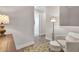 Inviting sitting area features a comfy armchair and stylish floor lamp, creating a cozy and relaxing ambiance at 880 Driving Range Ct, Reunion, FL 34747