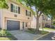 Charming two-story townhouse features a gray garage door, neutral stucco, and black shutters in a residential community at 2748 Clinton Heights Ct, Oviedo, FL 32765