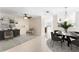 Open-concept living and dining area with neutral tile flooring, modern furnishings, and ample natural light at 2748 Clinton Heights Ct, Oviedo, FL 32765