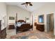 Large bedroom with a four poster bed, ceiling fan, and ensuite bathroom at 738 Knightsbridge Cir, Davenport, FL 33896