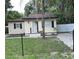 Well-maintained home featuring a white front door, black shutters, and a new fence for added privacy at 1531 Wauchula St, Intercession City, FL 33848