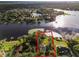 Aerial view of a waterfront house with a private dock and lush landscaping at 1700 Lake Markham Rd, Sanford, FL 32771