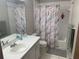 Clean bathroom featuring shower with bathtub, sink, vanity, mirror and gray accents at 3455 Jujube Dr, Orlando, FL 32810