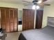 Bedroom featuring wood shutter closets, mirror and modern ceiling fan at 3455 Jujube Dr, Orlando, FL 32810