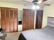 Bedroom featuring multiple closets, a ceiling fan, and neutral decor, offering ample storage at 3455 Jujube Dr, Orlando, FL 32810