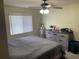 Bright bedroom features a ceiling fan, window, and plenty of storage space at 3455 Jujube Dr, Orlando, FL 32810