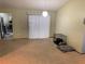 Bright living room area with sliding glass doors, connecting to the kitchen and featuring neutral-toned walls at 3455 Jujube Dr, Orlando, FL 32810