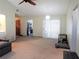 Open-concept living room with a ceiling fan, sliding glass doors to the back yard, and a view of the kitchen at 3455 Jujube Dr, Orlando, FL 32810