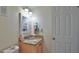 Cozy bathroom featuring a vanity with granite counters, framed mirror, and a convenient towel rack at 101 N Riverside Dr # 4100, New Smyrna Beach, FL 32168