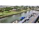 Serene view of a waterfront canal with boats docked and lush green landscaping along the banks at 101 N Riverside Dr # 4100, New Smyrna Beach, FL 32168