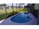 Screened-in pool with a kidney shape, ideal for relaxation at 124 Lancaster Dr, Davenport, FL 33897