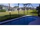 Relaxing kidney-shaped pool with screened enclosure at 124 Lancaster Dr, Davenport, FL 33897