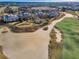 Aerial view of community near golf course and sand traps at 748 Desert Mountain Ct, Reunion, FL 34747