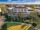 Aerial view of building with balconies and palm trees at 748 Desert Mountain Ct, Reunion, FL 34747