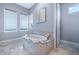 Bathroom with a free-standing bathtub and marble flooring at 748 Desert Mountain Ct, Reunion, FL 34747