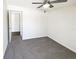 An empty bedroom featuring gray carpet, white walls and ceiling fan at 4367 Thornbriar Ln # 108, Orlando, FL 32822