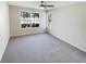 Neutral bedroom with a ceiling fan, a large window overlooking the pool, and neutral carpet at 4367 Thornbriar Ln # 108, Orlando, FL 32822