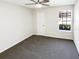 Bedroom with neutral walls, window with view to neighborhood and a ceiling fan at 4367 Thornbriar Ln # 108, Orlando, FL 32822