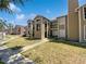 Exterior of home with a green lawn and blue sky at 4367 Thornbriar Ln # 108, Orlando, FL 32822