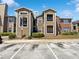 Apartment building exterior showcasing a well-maintained facade with ample parking and tidy landscaping at 4367 Thornbriar Ln # 108, Orlando, FL 32822