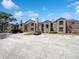 Attractive apartment building exterior showcasing a well-maintained facade and ample parking on a sunny day at 4367 Thornbriar Ln # 108, Orlando, FL 32822