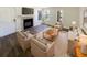 Bright living room features a fireplace, wood floors, comfortable seating, and natural light from the windows at 4367 Thornbriar Ln # 108, Orlando, FL 32822