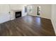 Bright living room features a fireplace, wood floors, and natural light from the windows and exterior door at 4367 Thornbriar Ln # 108, Orlando, FL 32822