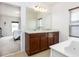 Double vanity bathroom with a large mirror and natural light at 122 Blue Cypress Drive, Davenport, FL 33837