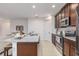 Granite kitchen island with stainless steel appliances and ample counter space at 122 Blue Cypress Drive, Davenport, FL 33837