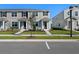 Charming two-story townhome showcasing a welcoming entrance and well-manicured lawn at 3201 Douglas Fir Dr, Apopka, FL 32703