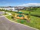 A view of a community playground with slides, surrounded by green lawns and residential homes at 4234 Sunset Preserve Blvd, Orlando, FL 32820