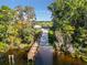 Picturesque lakefront dock with lush greenery and a charming gazebo, offering a tranquil retreat at 4234 Sunset Preserve Blvd, Orlando, FL 32820