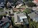 Aerial view showcasing a home's backyard pool and a large, flat roof at 9227 Cypress Cove Dr, Orlando, FL 32819