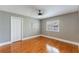 Well-lit bedroom with hardwood floors and window with shutters at 9227 Cypress Cove Dr, Orlando, FL 32819