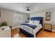 Bright bedroom with hardwood floors and a blue upholstered bed at 9227 Cypress Cove Dr, Orlando, FL 32819