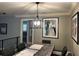 Modern dining room with concrete table, pendant lighting, and gray walls at 9227 Cypress Cove Dr, Orlando, FL 32819