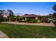 House exterior with manicured lawn and paved driveway at dusk at 9227 Cypress Cove Dr, Orlando, FL 32819