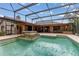 Screened pool and spa with a covered patio at 9227 Cypress Cove Dr, Orlando, FL 32819