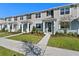 Modern townhouse exterior featuring neutral siding, black shutters, and well-maintained landscaping at 3217 Douglas Fir Dr, Apopka, FL 32703