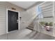 Apartment entryway with a black front door, white railings, and stairs at 3176 Feltrim Pl # 305, Kissimmee, FL 34747